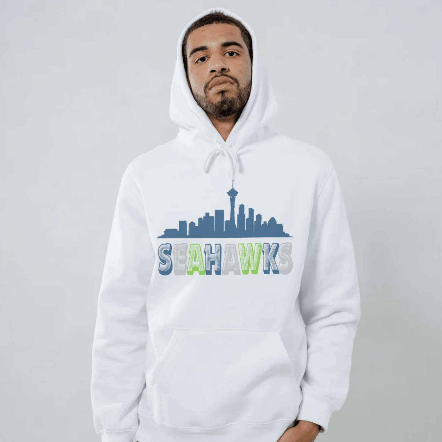 Person wearing a white hoodie with 'Seahawks' design with city skyline